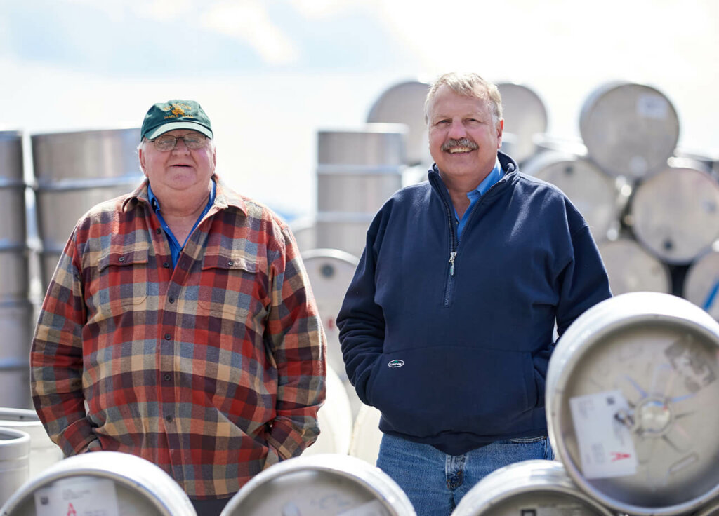 two men near maple barrels