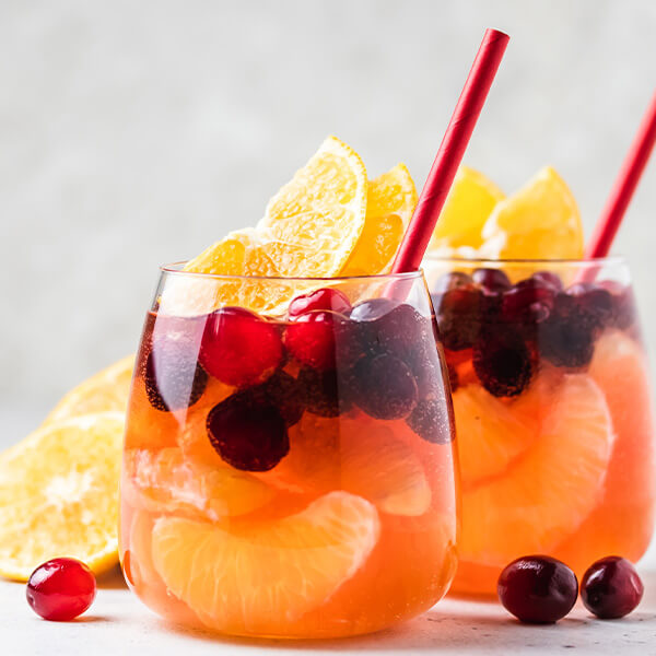 cocktail glasses with oranges and maple